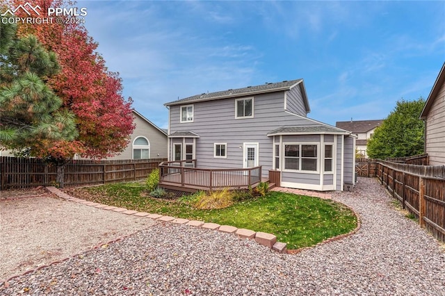 back of property with a wooden deck