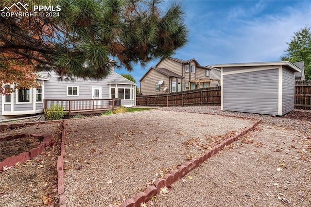 view of yard featuring a shed and a deck