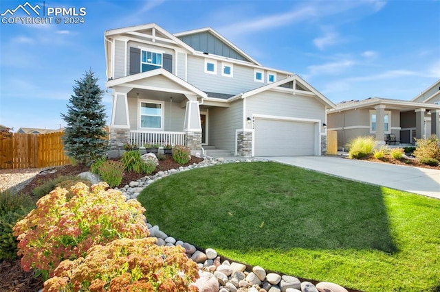 8032 Wheatland Dr, Colorado Springs, CO 80908 - craftsman-style house with board and batten siding, covered porch, stone siding, fence, and driveway
