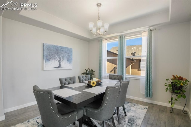 8032 Wheatland Dr, Colorado Springs, CO 80908 - dining room featuring a tray ceiling, wood finished floors, a notable chandelier, and baseboards
