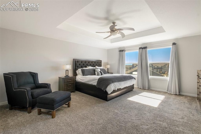 8032 Wheatland Dr, Colorado Springs, CO 80908 - carpeted bedroom featuring a raised ceiling, baseboards, and a ceiling fan