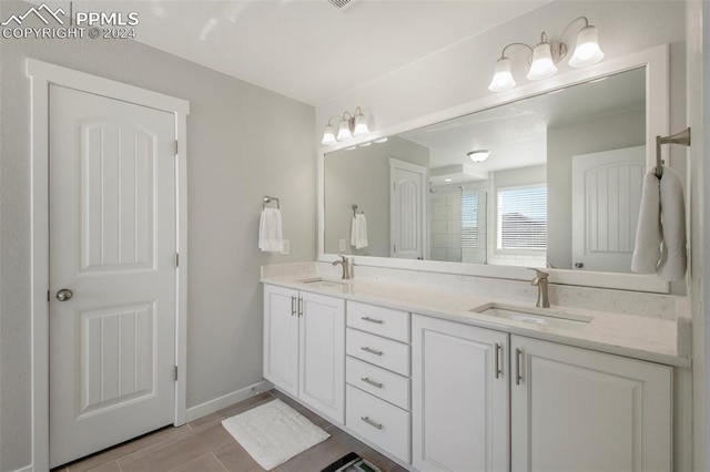 8032 Wheatland Dr, Colorado Springs, CO 80908 - full bath with a shower with shower door, double vanity, a sink, and wood finished floors