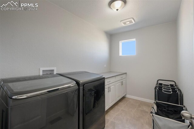 8032 Wheatland Dr, Colorado Springs, CO 80908 - washroom with separate washer and dryer, baseboards, light tile patterned floors, visible vents, and cabinet space