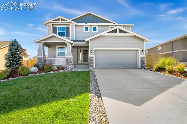 8032 Wheatland Dr, Colorado Springs, CO 80908 - craftsman inspired home featuring a front yard, board and batten siding, fence, and covered porch