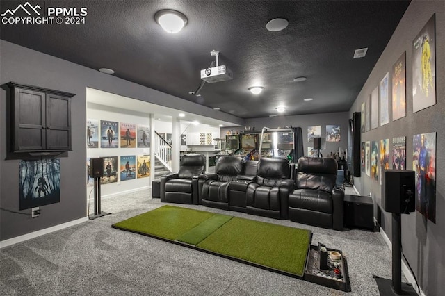 8032 Wheatland Dr, Colorado Springs, CO 80908 - home theater featuring a textured ceiling, carpet flooring, baseboards, and visible vents