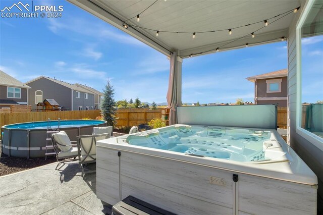 8032 Wheatland Dr, Colorado Springs, CO 80908 - view of patio featuring a fenced in pool, fence, and a hot tub
