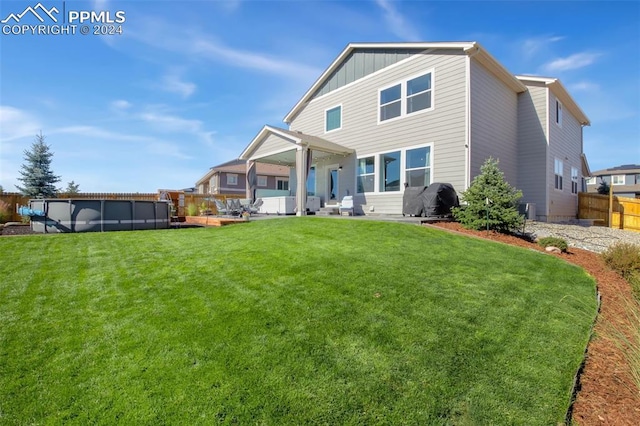 8032 Wheatland Dr, Colorado Springs, CO 80908 - rear view of property featuring a fenced in pool, a yard, board and batten siding, and fence