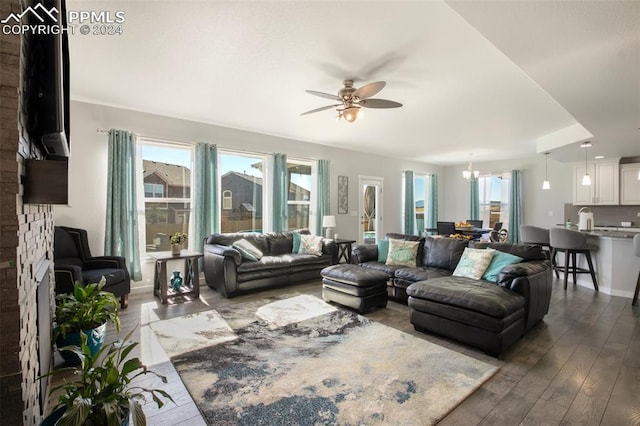 8032 Wheatland Dr, Colorado Springs, CO 80908 - living room with ceiling fan with notable chandelier and dark wood finished floors