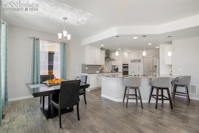 8032 Wheatland Dr, Colorado Springs, CO 80908 - dining room featuring recessed lighting, visible vents, an inviting chandelier, and wood finished floors
