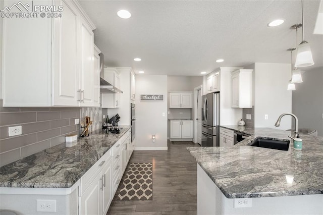 8032 Wheatland Dr, Colorado Springs, CO 80908 - kitchen with a peninsula, white cabinetry, dark wood-type flooring, appliances with stainless steel finishes, and a sink