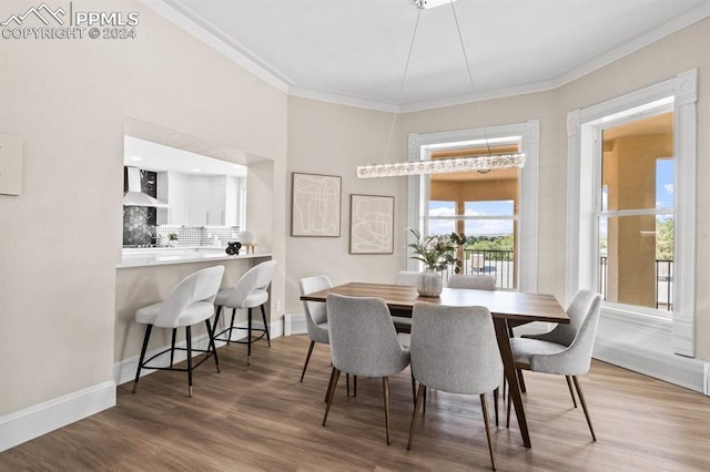 dining room featuring hardwood / wood-style flooring and ornamental molding