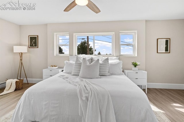 bedroom with light hardwood / wood-style floors and ceiling fan