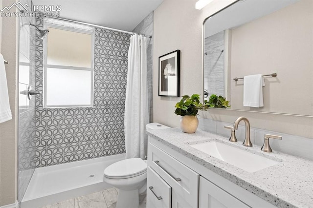 bathroom featuring walk in shower, vanity, and toilet