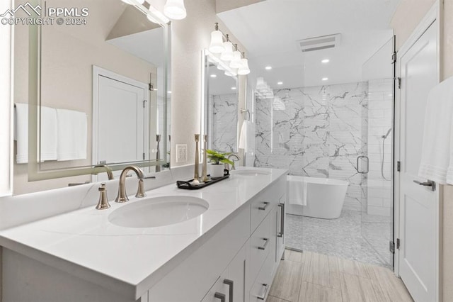 bathroom with shower with separate bathtub, vanity, and tile patterned floors