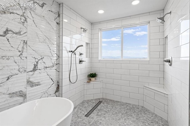 bathroom featuring shower with separate bathtub