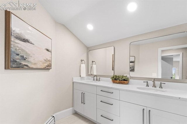 bathroom with vaulted ceiling and vanity