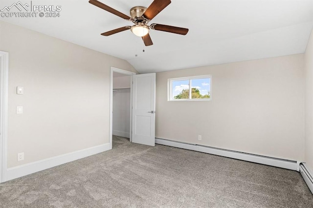 unfurnished bedroom with light carpet, a baseboard heating unit, vaulted ceiling, and ceiling fan