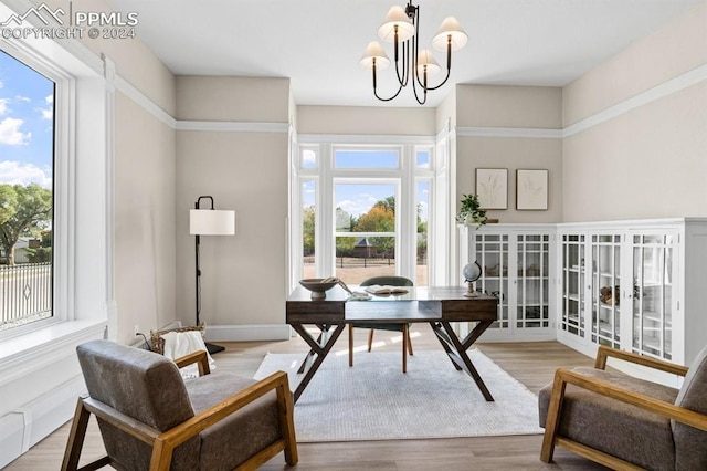 office area featuring an inviting chandelier, light hardwood / wood-style flooring, and plenty of natural light