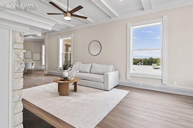 living room featuring beam ceiling, ornamental molding, hardwood / wood-style floors, and ceiling fan