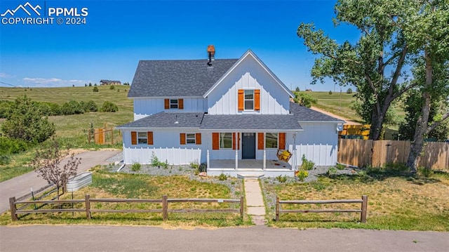 modern inspired farmhouse with a porch and a rural view