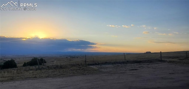 yard at dusk with a rural view