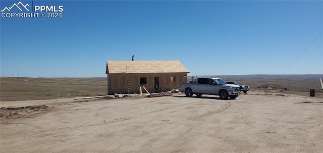 view of car parking featuring a rural view