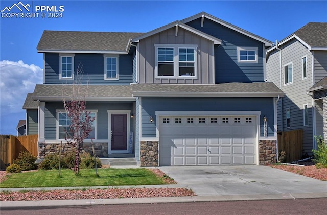 craftsman inspired home featuring a front lawn and a garage