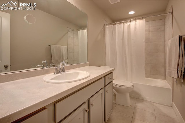 full bathroom featuring vanity, shower / bath combo with shower curtain, toilet, and tile patterned floors