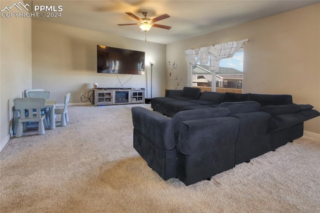 carpeted living room with ceiling fan