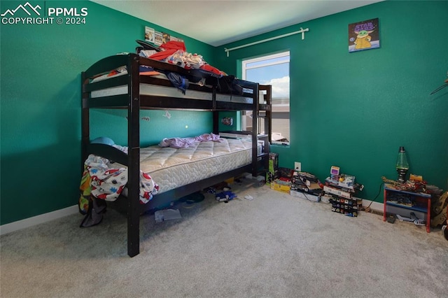 bedroom featuring a water view and carpet