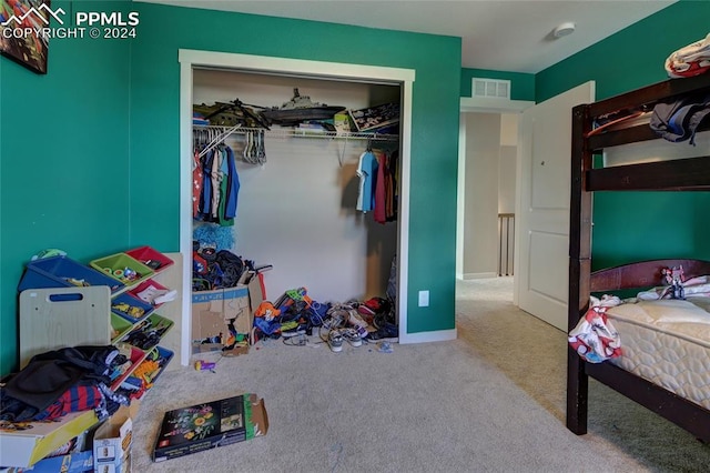 bedroom with carpet and a closet