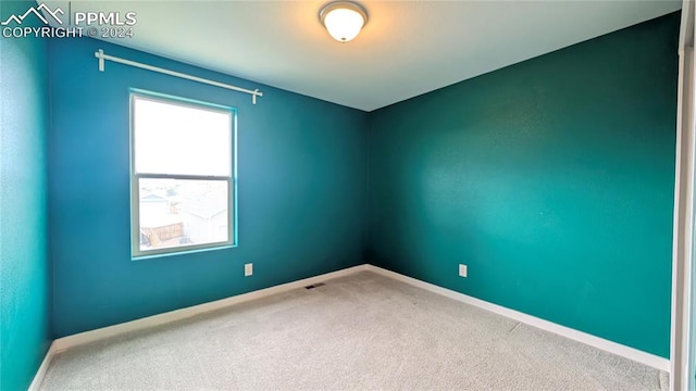 unfurnished room with carpet flooring