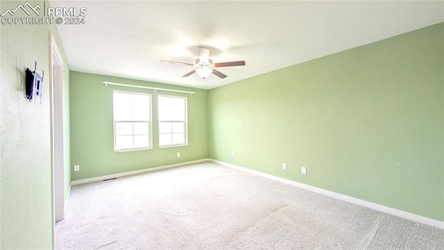 carpeted empty room with ceiling fan