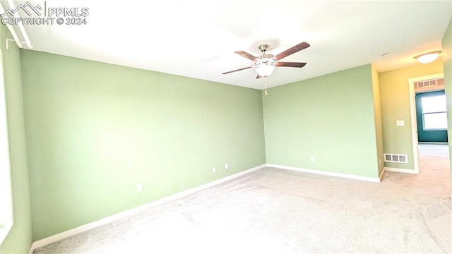 carpeted empty room featuring ceiling fan