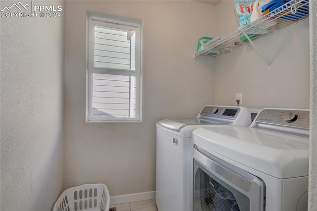 washroom with light tile patterned flooring and washing machine and clothes dryer