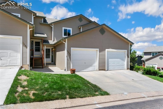 view of front property with a garage and a front lawn