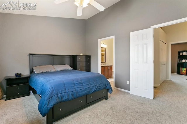 carpeted bedroom featuring high vaulted ceiling, ceiling fan, and ensuite bathroom