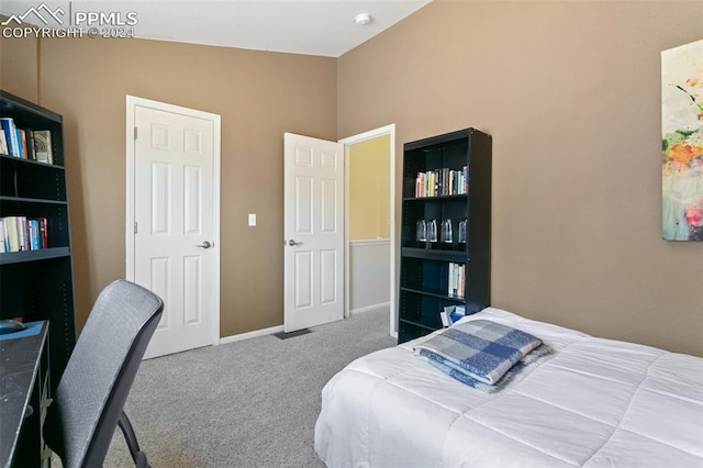 carpeted bedroom with vaulted ceiling