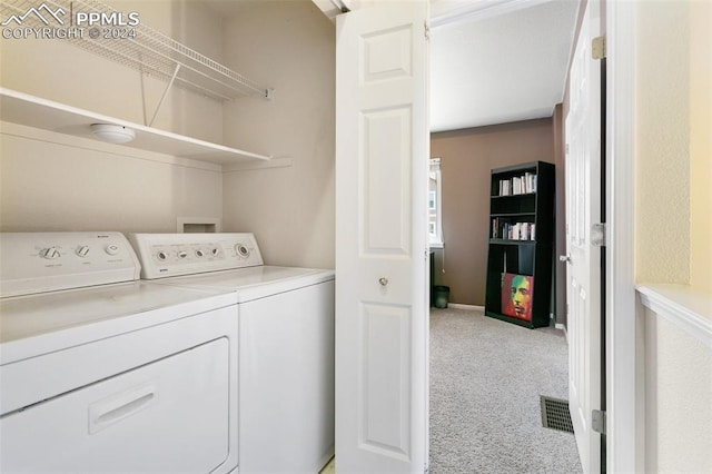 laundry area featuring light carpet and washing machine and clothes dryer