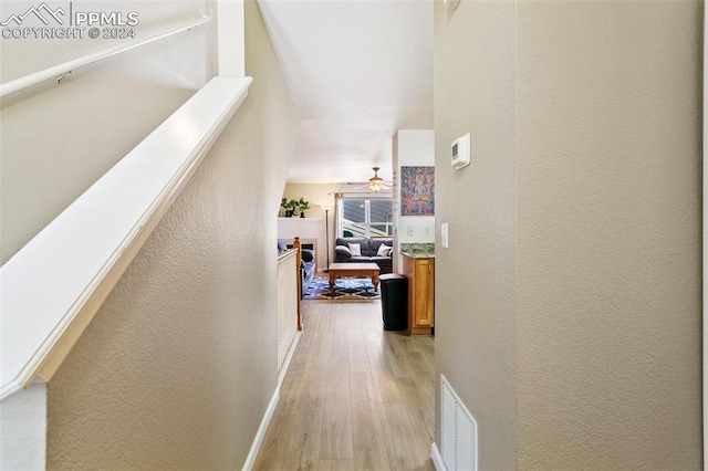 hall with light hardwood / wood-style floors