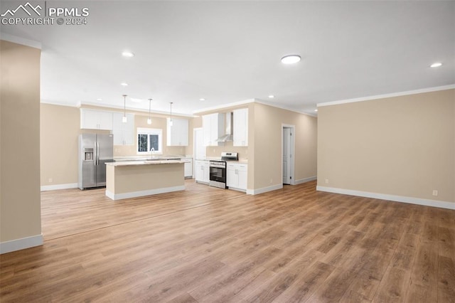 unfurnished living room featuring light wood-type flooring, crown molding, and sink