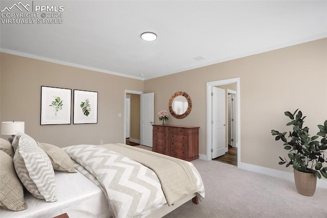 bedroom with carpet floors and ornamental molding