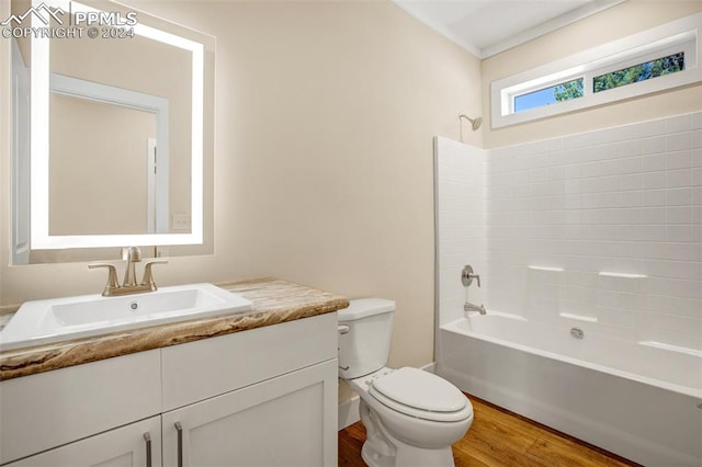 full bathroom with tub / shower combination, vanity, toilet, and wood-type flooring