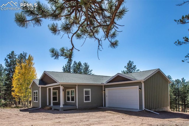 ranch-style house with a garage and covered porch