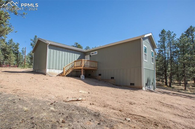 rear view of house with a wooden deck