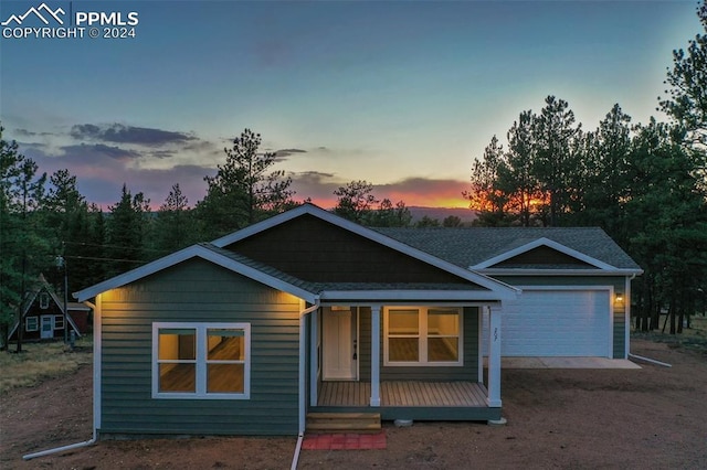 view of front of house featuring a porch and a garage