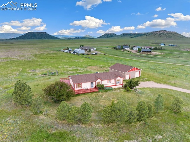 birds eye view of property with a mountain view and a rural view