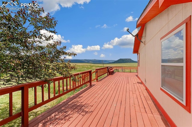 wooden deck with a mountain view