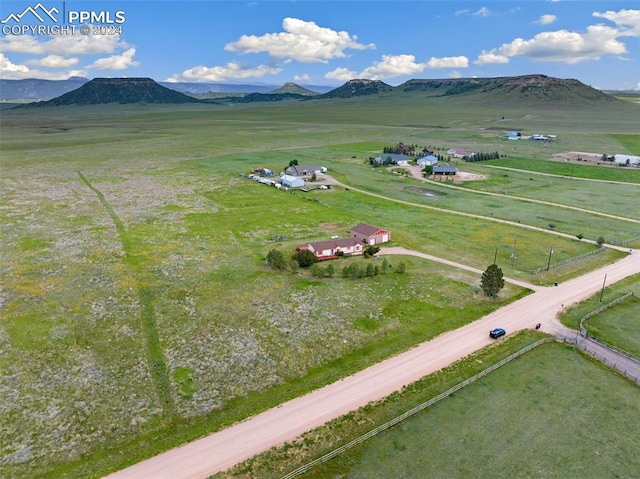 birds eye view of property with a mountain view and a rural view