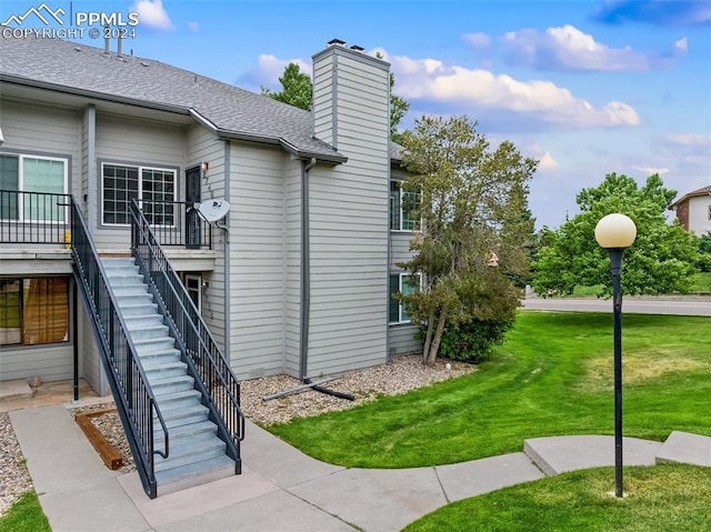 view of property exterior featuring a lawn